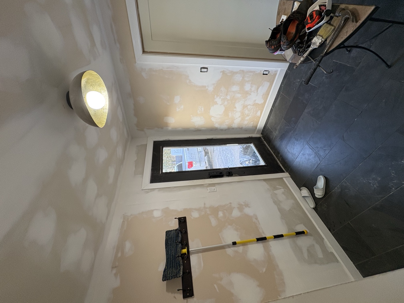 Drywall repair and surface preparation before the finish coat