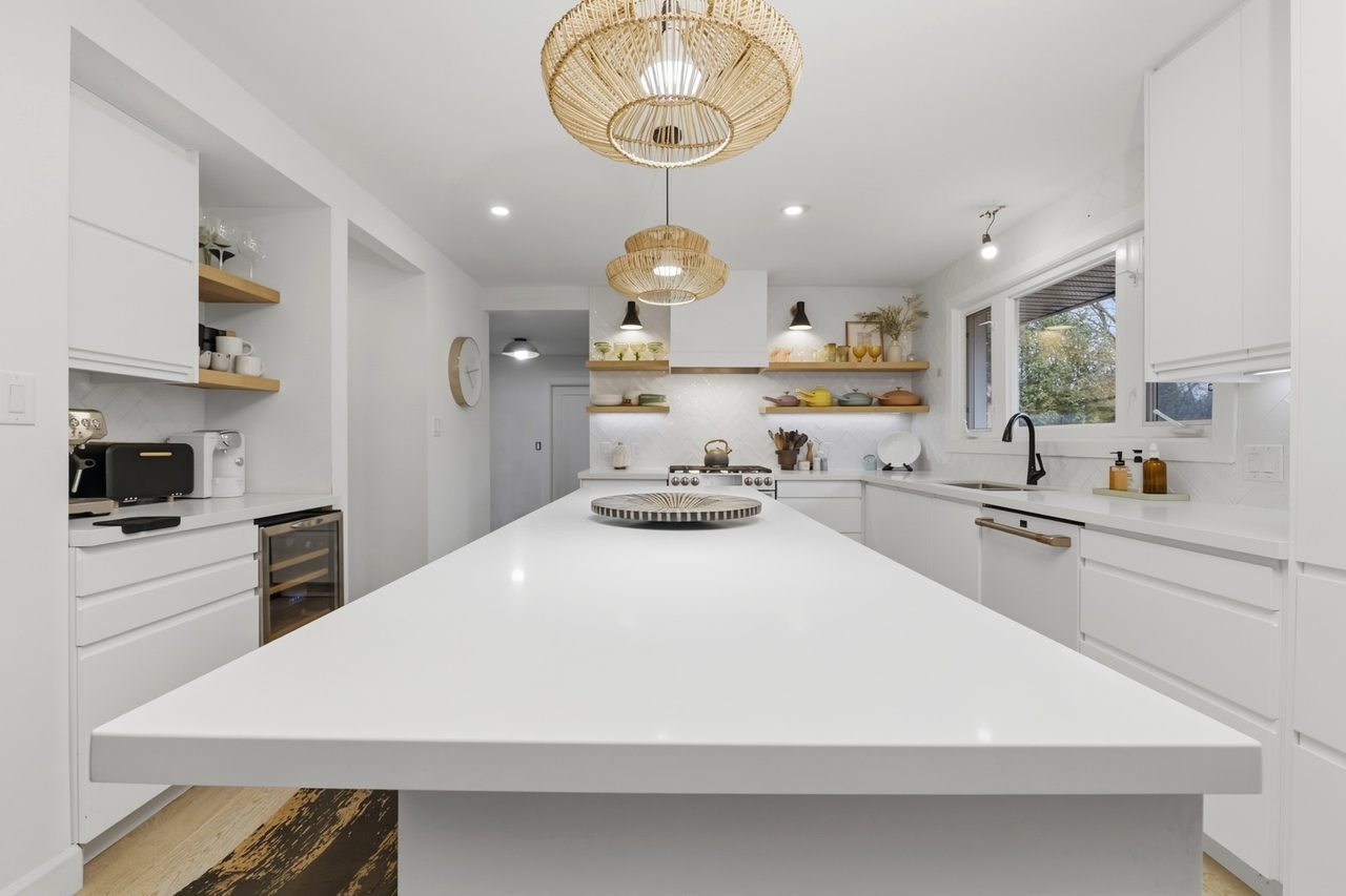 Custom kitchen with island and pendant lighting by Koenig Painting and Design